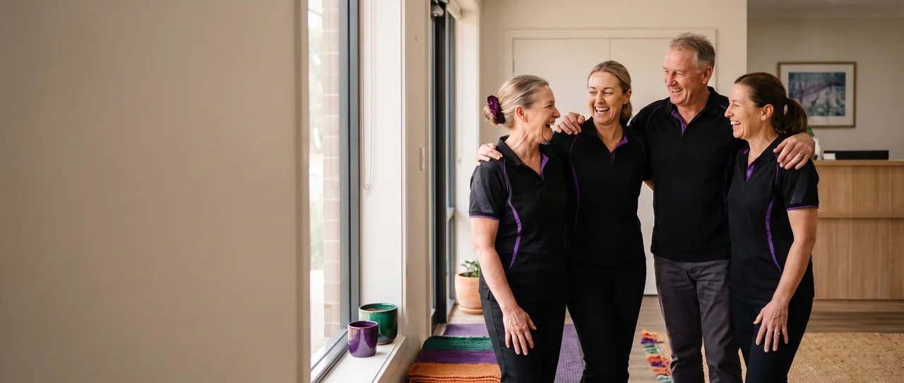 Clinic team cheering in their doorway on opening morning