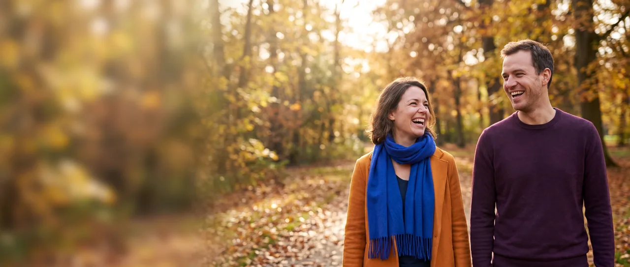 Integration therapist and client laughing on a park walk